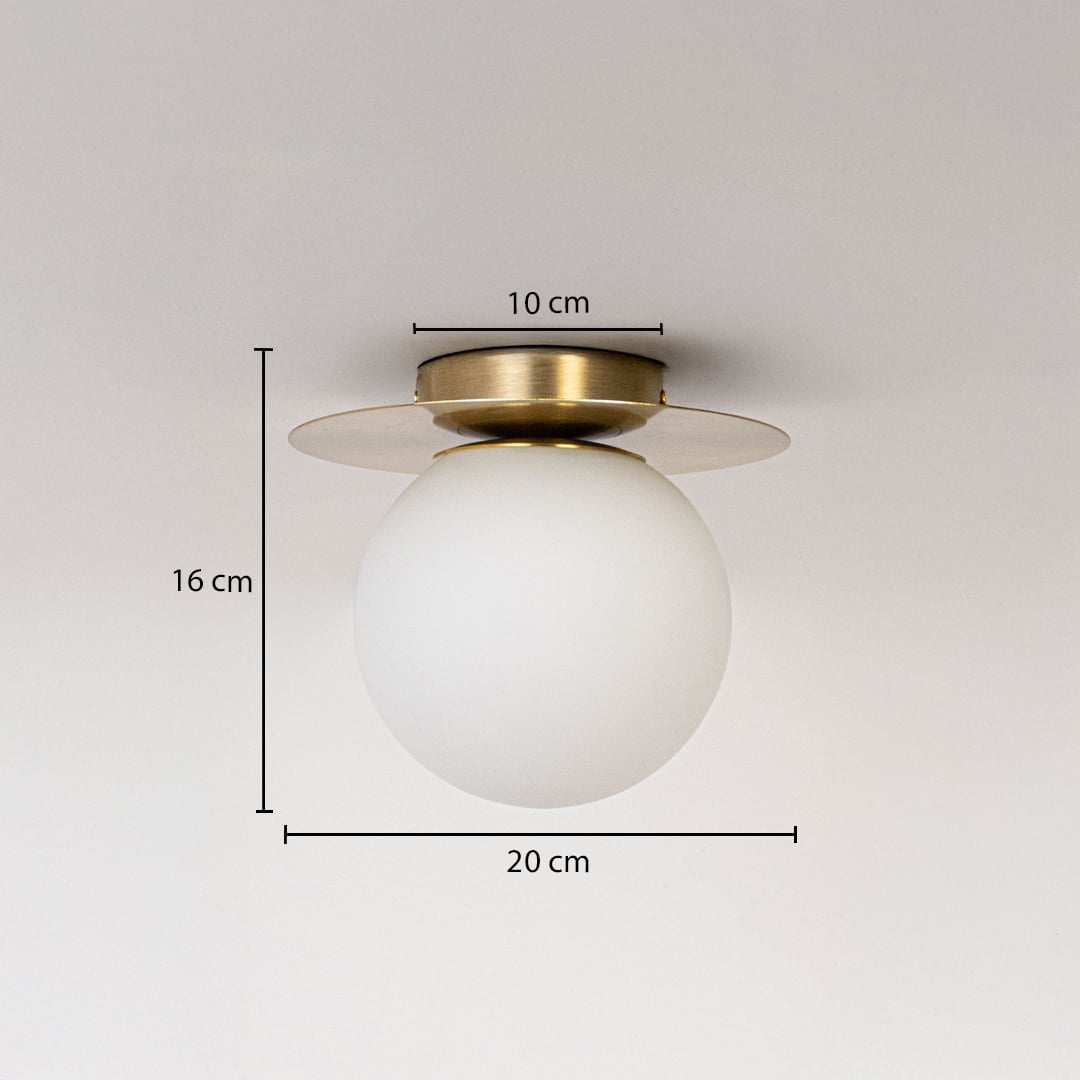 Ceiling light with brushed gold base and frosted glass globe shown with size dimensions 16 cm height 20 cm width and 10 cm base.