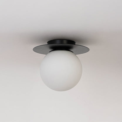 Ceiling light with black finish base and frosted glass globe shade shown switched off on plain white background.