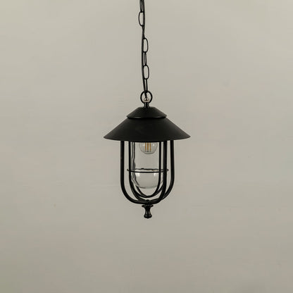 Outdoor hanging lantern with light off shown on a white background featuring a clear glass body and sleek metal frame with smooth detailing.