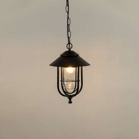 Black metal hanging outdoor lantern with glass enclosure glowing on white background ideal for porch entrance and exterior decor lighting.