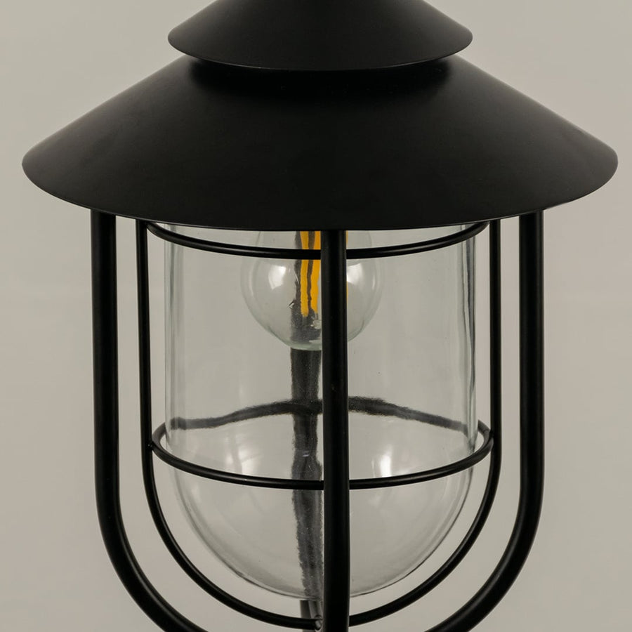 A closeup view of the outdoor hanging lantern showing the smooth metal finish and clear rounded glass panels highlighting the craftsmanship.
