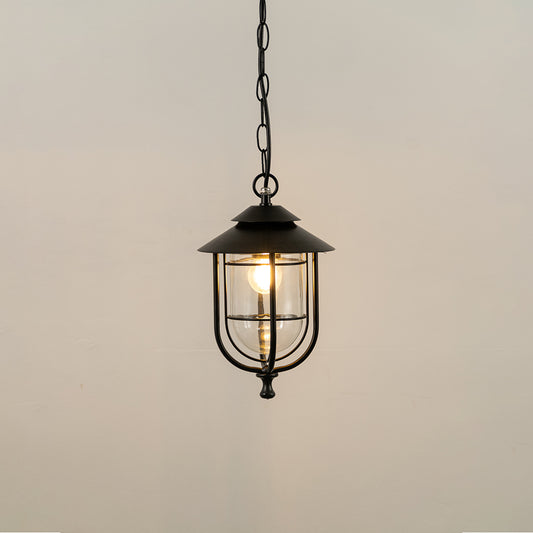 Black metal hanging outdoor lantern with glass panels glowing on white background ideal for gate entrance and exterior lighting decor.