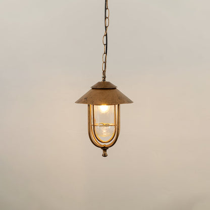 A classic hanging lantern with the light on showcasing its clear glass panels and curved metal frame against a simple white background for product detailing.