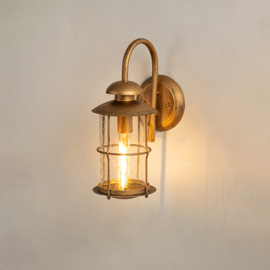 Industrial brass gooseneck outdoor wall sconce on white background with a clear glass cage lantern shade for porch decor.