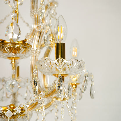 Closeup image of clear glass arm chandelier for modern dining room decor styling with elegant glass detailings.