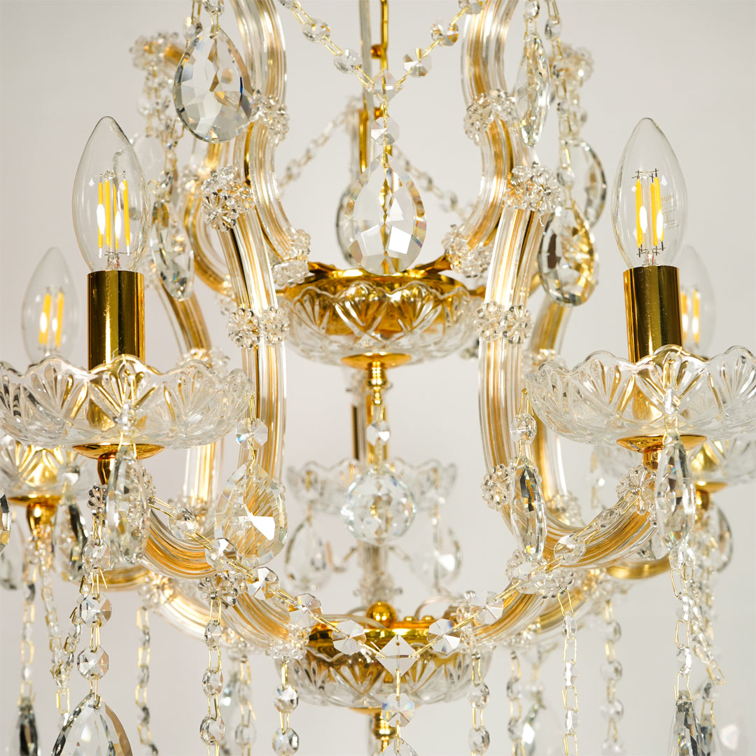 Closeup image of clear glass arm chandelier for elegant living room decor styling with beautiful glass accents.