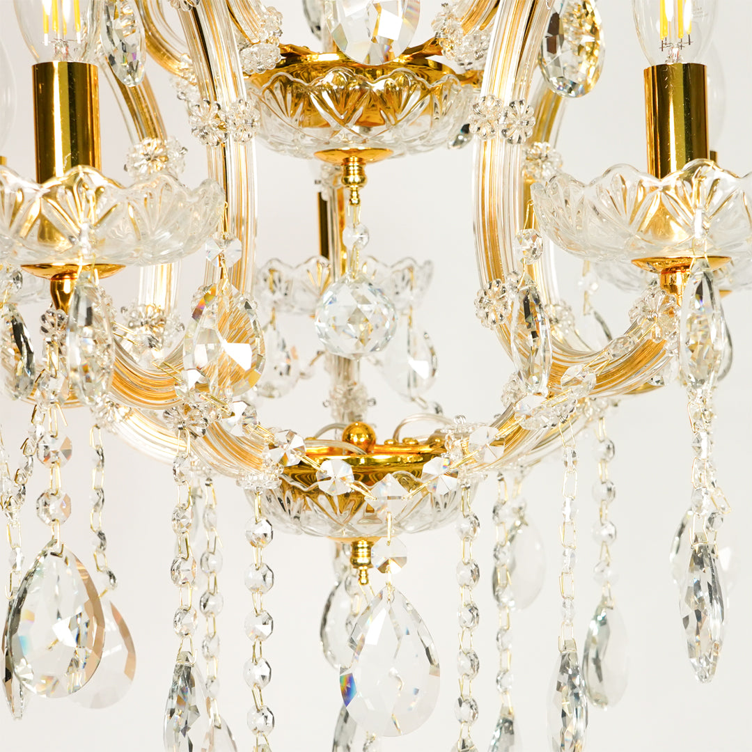Closeup image of clear glass arm chandelier for modern dining room decor styling with beautiful glass detailings.
