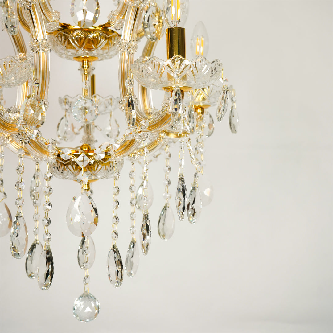 Closeup image of clear glass arm chandelier for elegant living room decor styling with beautiful glass accents.