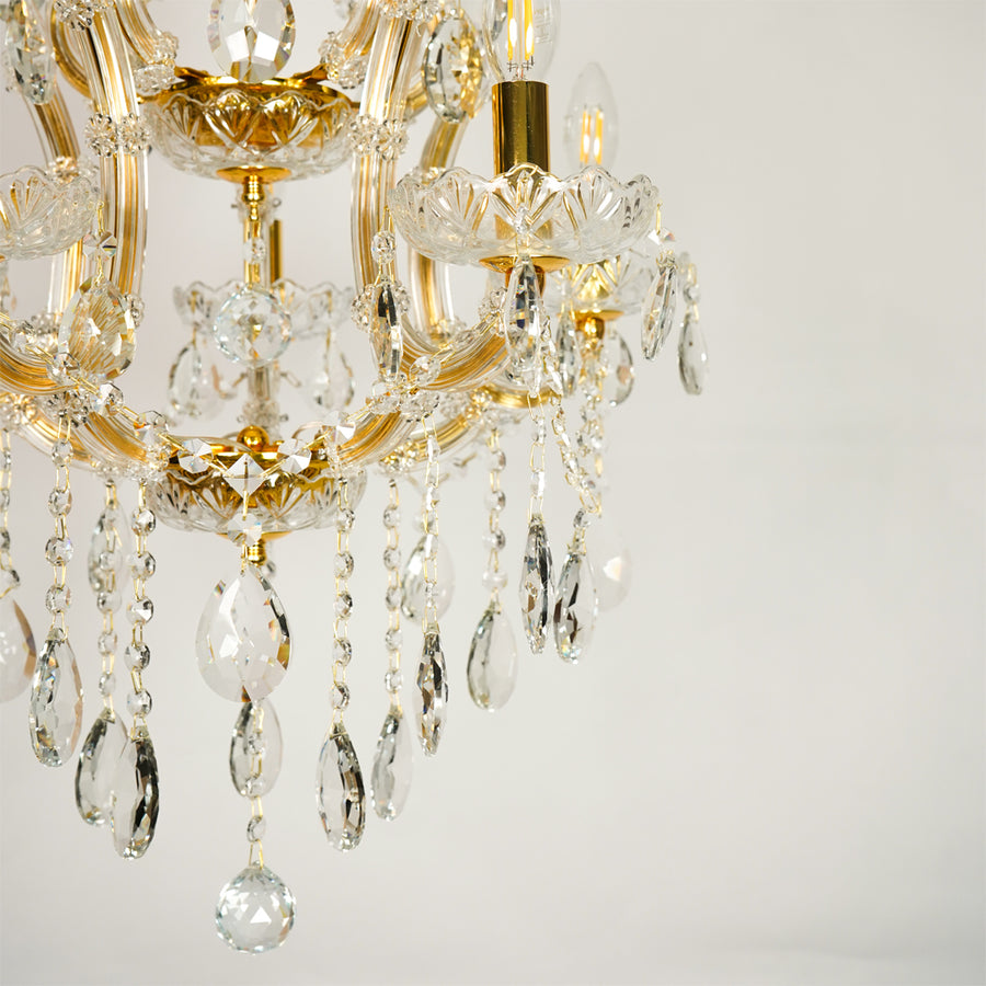Closeup image of clear glass arm chandelier for elegant living room decor styling with beautiful glass accents.