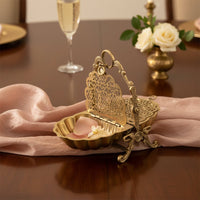 Gold metal decorative napkin holder lifestyle image with floral detailing for classic luxury table decor.