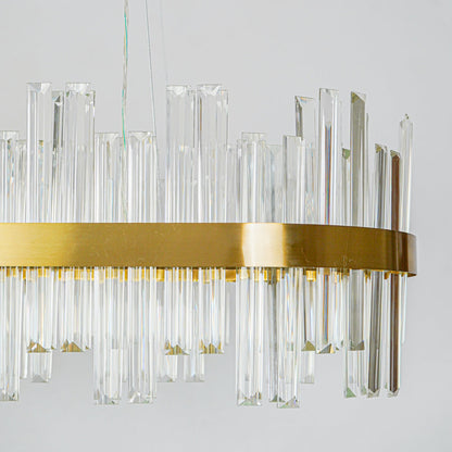 Close up crystal wall light with gold metal frame and structured glass elements mounted on white wall background for premium home decor lighting.