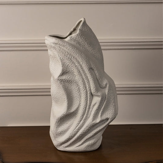 White ceramic textured vase with artistic wavy surface placed on white background for elegant modern home decor.