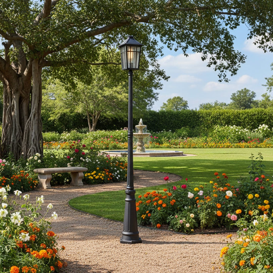 Tall outdoor post lamp in black metal installed on garden walkway enhancing greenery with soft ambient lighting and classic outdoor charm.
