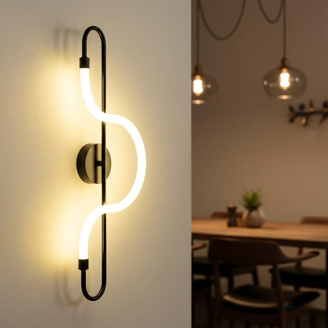 Modern black curved loop neon LED wall sconce casting a bright warm glow next to a wooden dining room table setting.