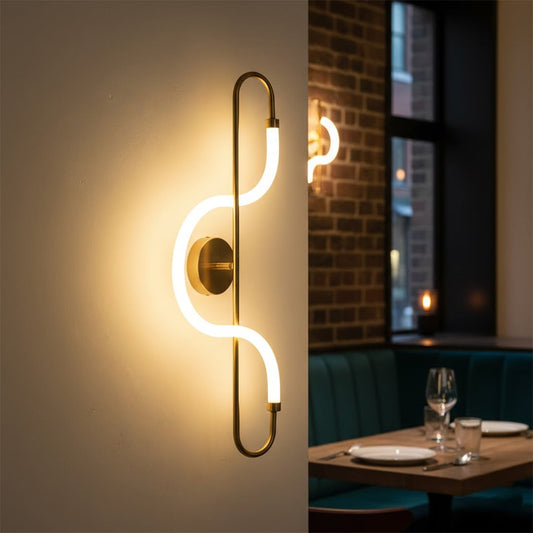Modern gold LED wall light with artistic glow for contemporary living room and luxury decor spaces.

