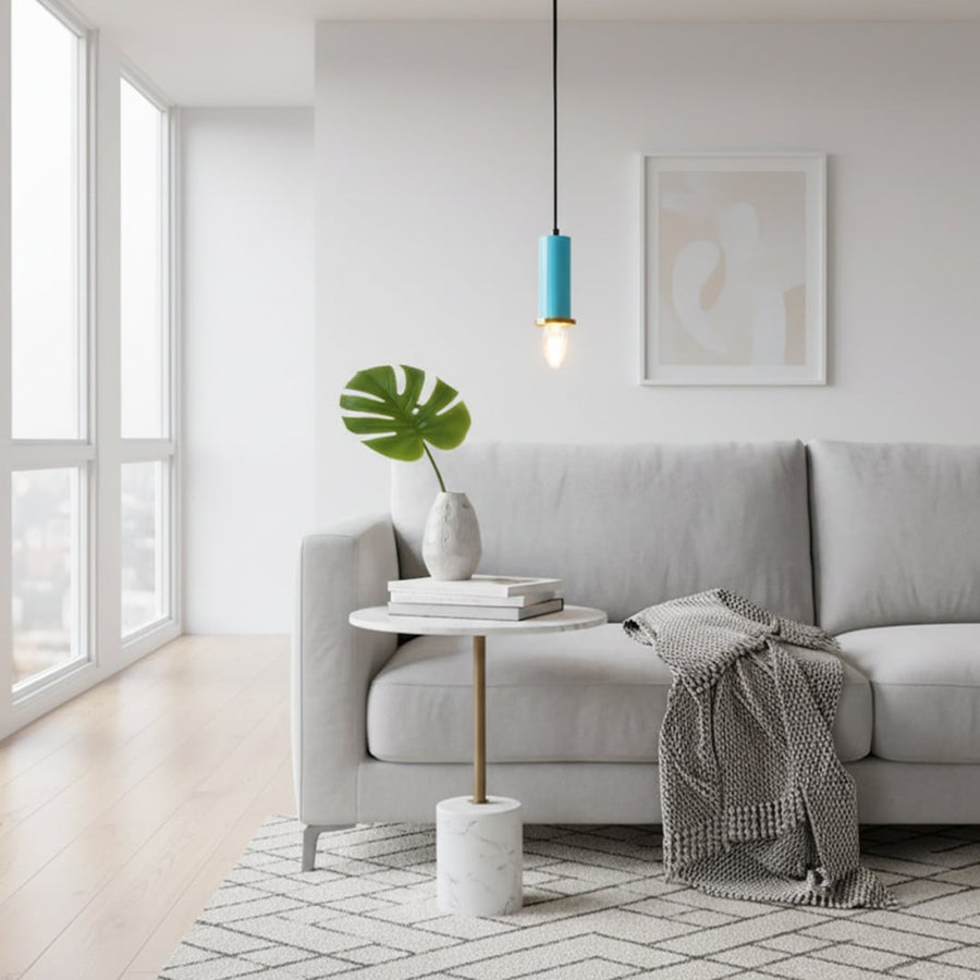 Blue metal pendant light hanging above a side table creating warm ambient lighting in a modern living room seating area.