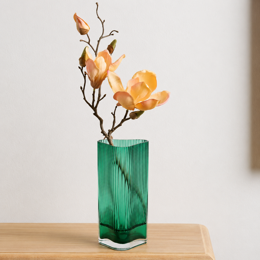 Lifestyle image of long green luxury glass vase for elegant dining table decor styling and modern home interior decoration.