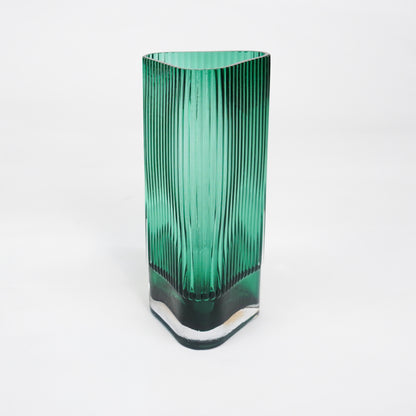 White background image of long green luxury glass vase for elegant tabletop decor styling and modern interior room design.