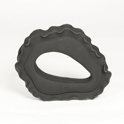 Contemporary dark grey ceramic artistic sculpture for minimalist living room decor placement.