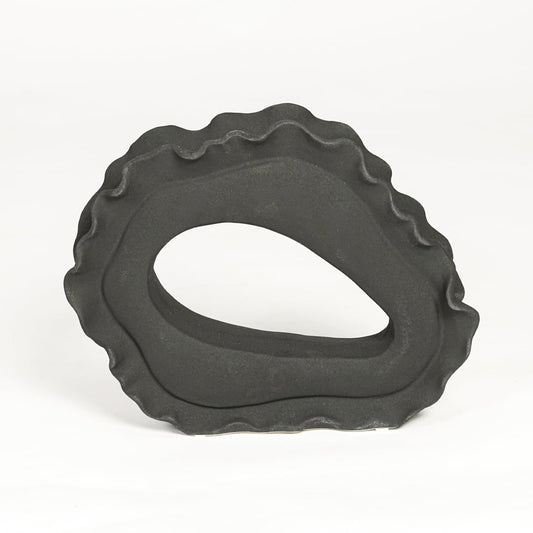 Contemporary dark grey ceramic artistic sculpture for minimalist living room decor placement.