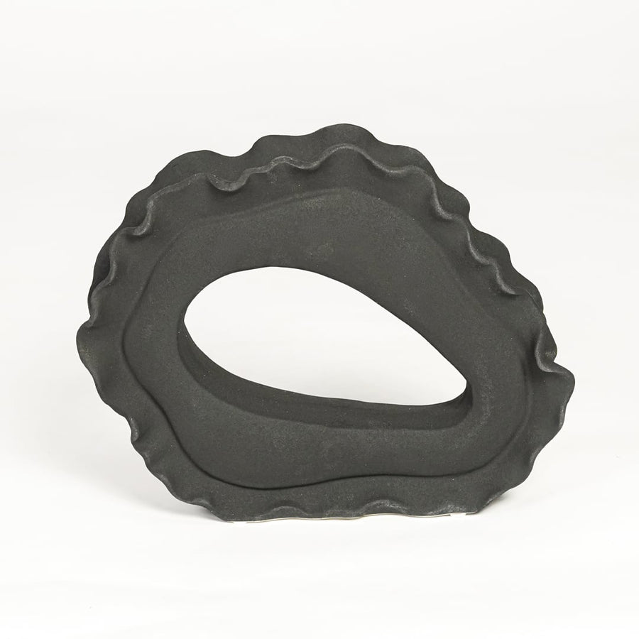 Contemporary dark grey ceramic artistic sculpture for minimalist living room decor placement.