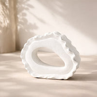 White ceramic decorative bowl with organic sculptural design styled for elegant tabletop decor and modern home interiors.