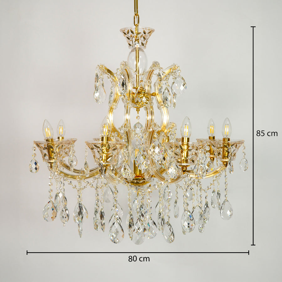 Gold-finished multi-arm chandelier with clear crystal teardrop pendants and candle-style bulbs, shown against a light gray background with dimension lines indicating 80 cm width and 85 cm height.