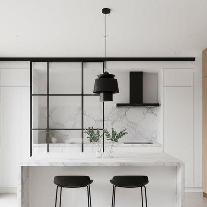 Black metal pendant light above kitchen island adding contemporary elegance and warm ambient lighting to interiors.