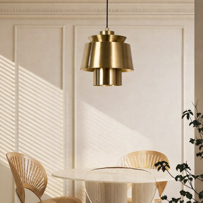 Brass metal pendant light above dining table adding modern luxury and warm ambient lighting to elegant interiors.