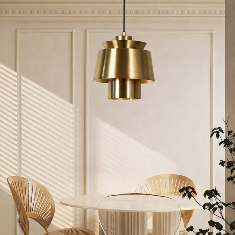 Brass metal pendant light above dining table adding modern luxury and warm ambient lighting to elegant interiors.
