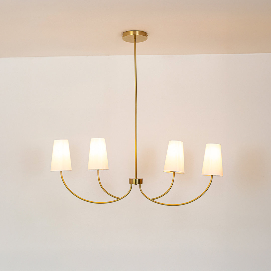 Gold metal chandelier with fabric drum shades designed for refined modern ceiling lighting in stylish home interiors.