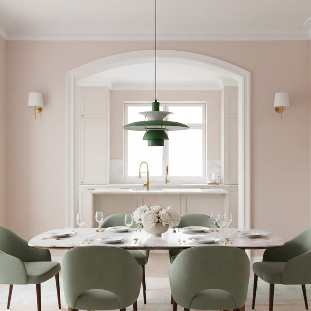 Green layered metal pendant light suspended above dining table in bright contemporary spaces.