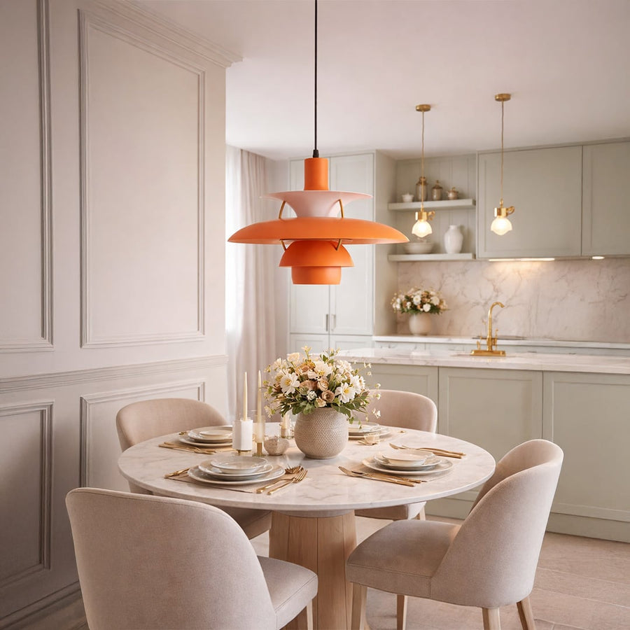 Peach orange metal pendant light above dining table adding warm modern elegance to stylish interiors.