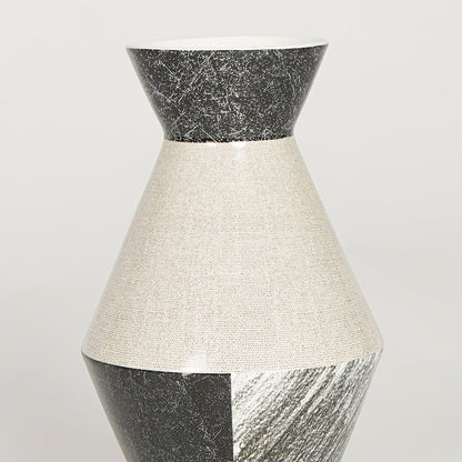 Closeup of black and white glazed ceramic vase with detailed textured finish ideal for shelf or side table decor styling.