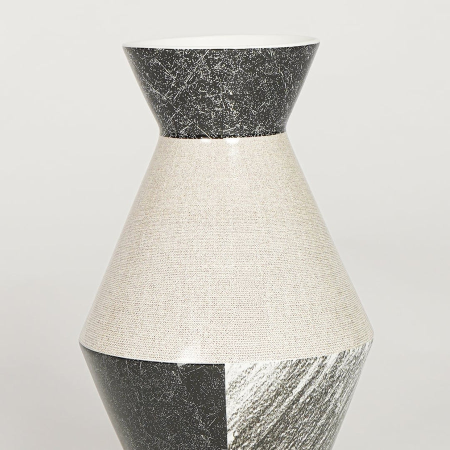 Closeup of black and white glazed ceramic vase with detailed textured finish ideal for shelf or side table decor styling.