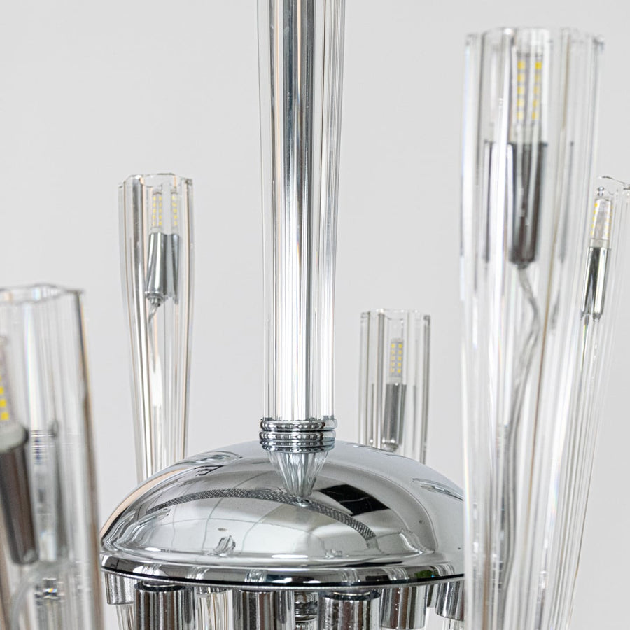 Closeup of modern chrome and clear glass chandelier showing curved arms perfect for stylish contemporary ceiling lighting.