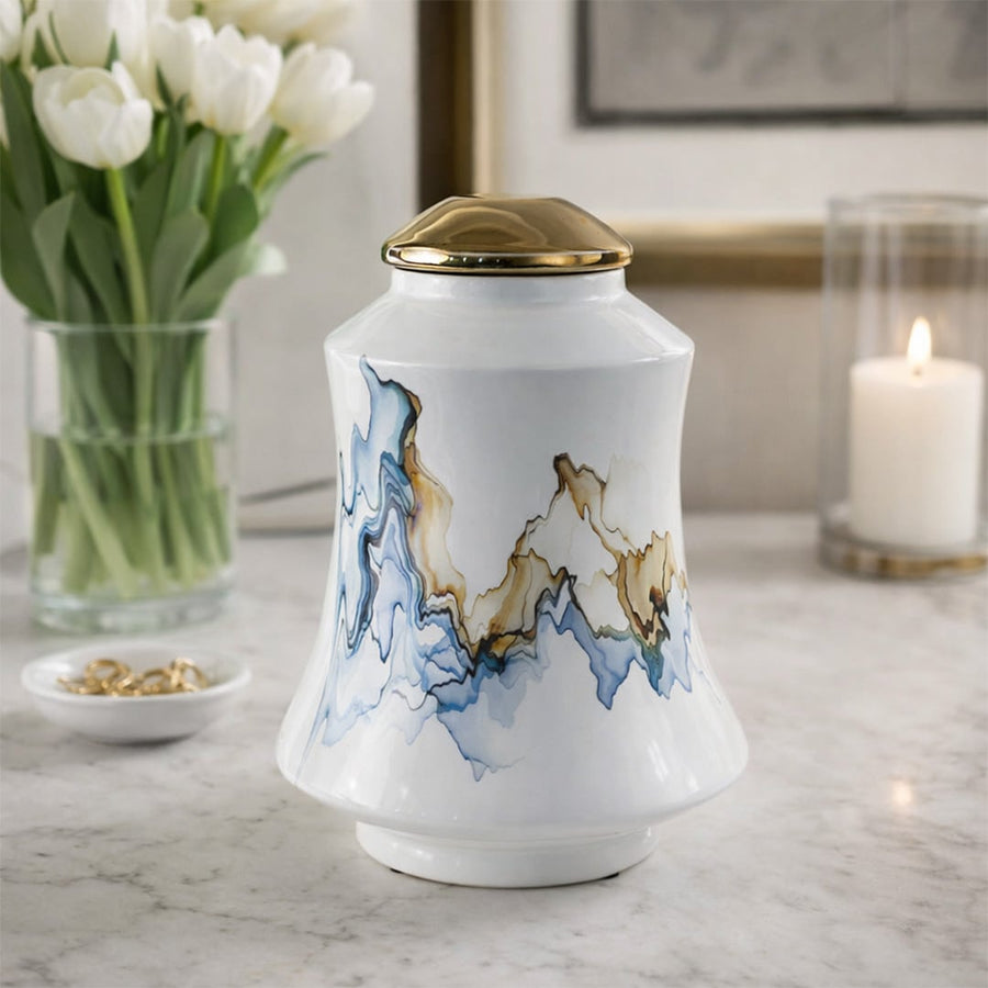 White ceramic decorative jar with blue wave artwork styled beside flowers for elegant contemporary home decor settings.