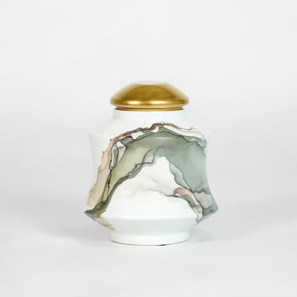 White marble ceramic decorative jar with gold lid for elegant tabletop styling and contemporary home decor displays.
