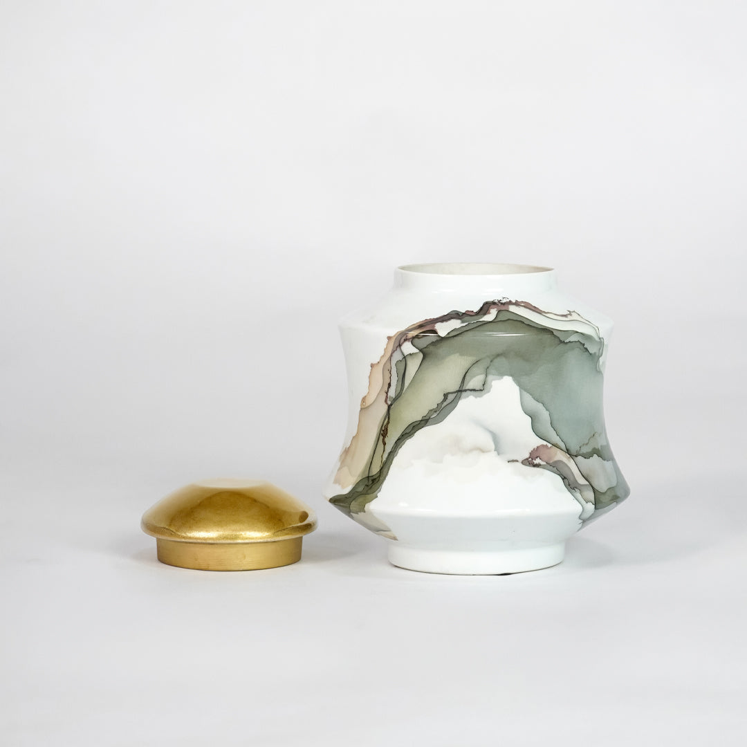 White marble ceramic decorative jar with matching gold lid for luxury shelf styling and modern home decor displays.