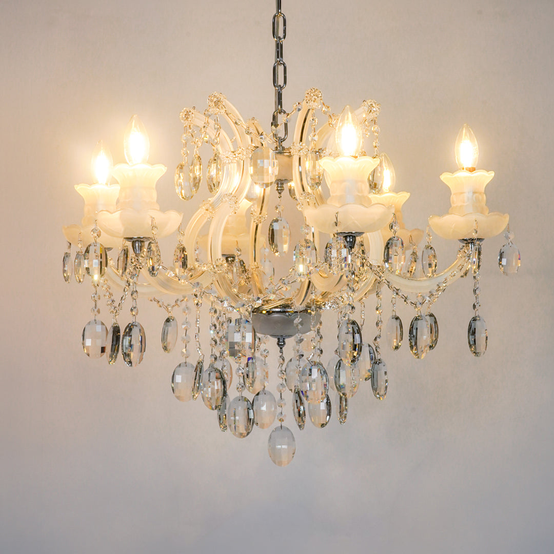 White background image of gold metal candle style chandelier for modern living room decor styling with a bright warm glow.