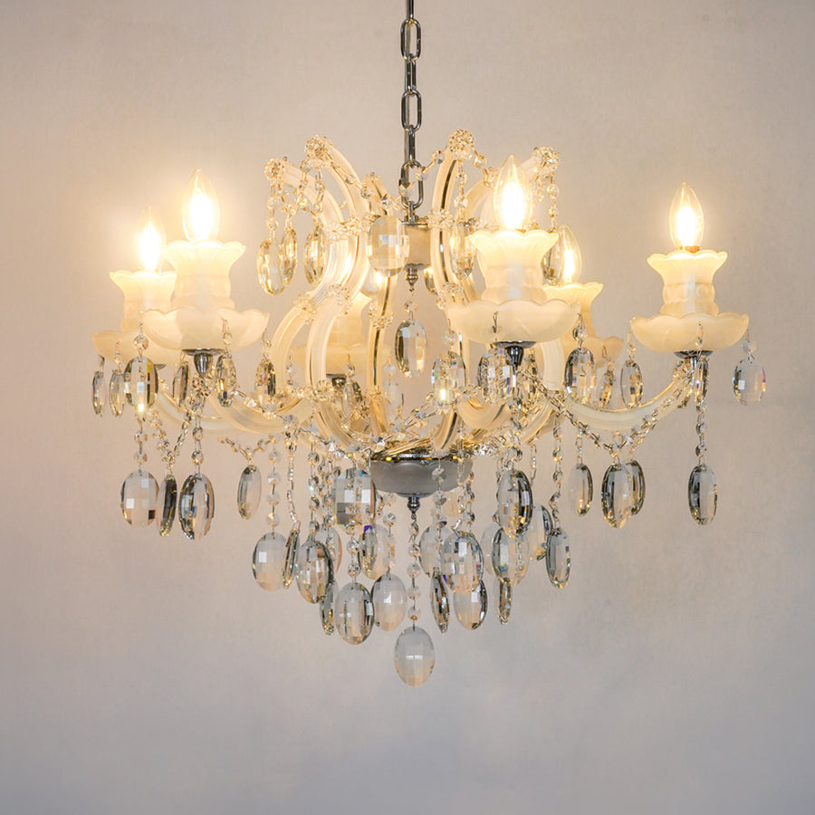 White background image of gold metal candle style chandelier for modern living room decor styling with a bright warm glow.
