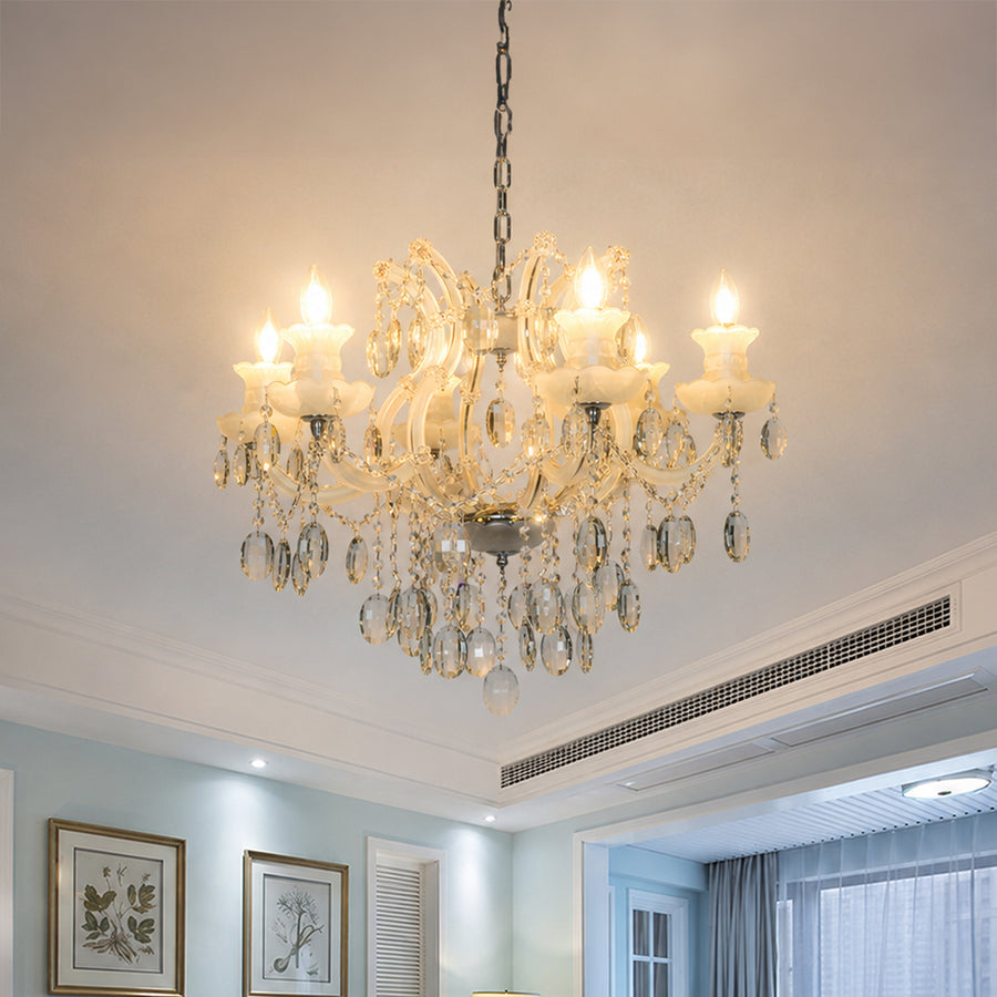 Lifestyle image of gold metal candle style chandelier for luxury living room decor styling with elegant crystal detailing.
