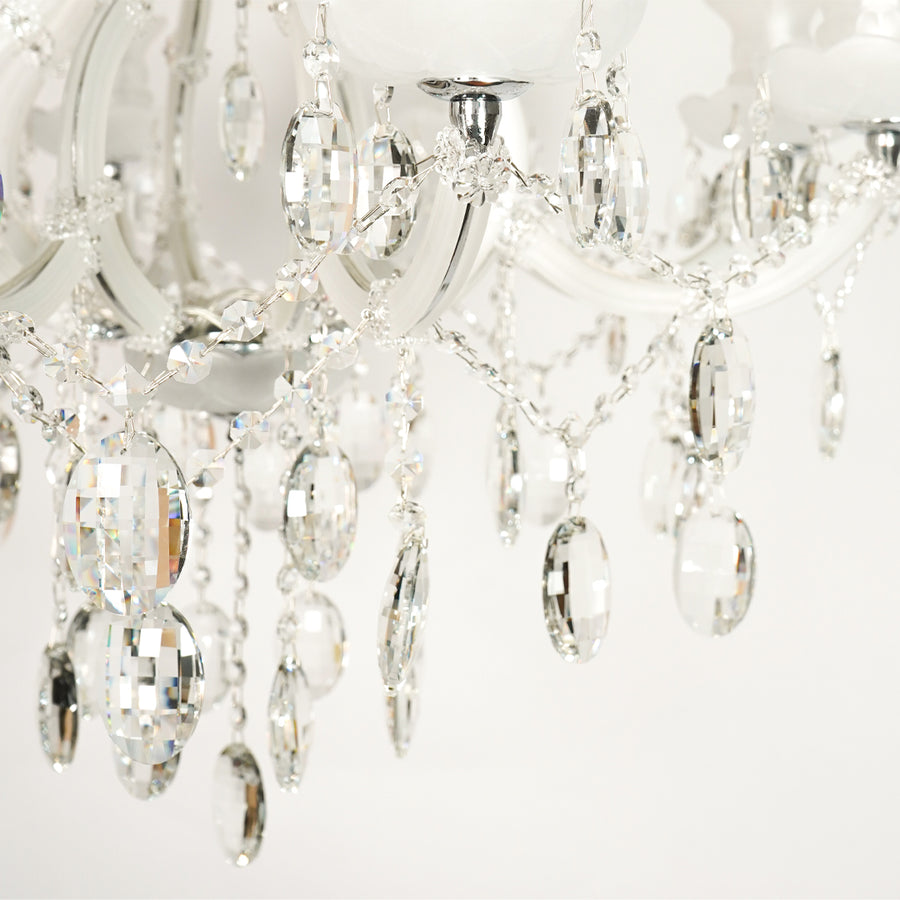 Closeup image of large gold metal candle style chandelier for modern dining room decor styling with elegant crystal detailings.