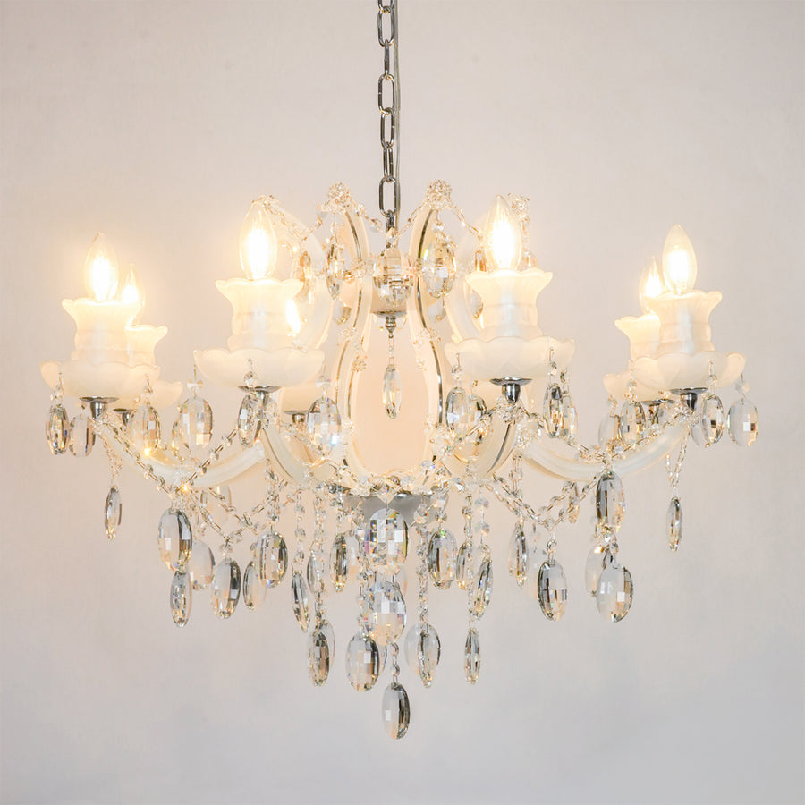 White background image of large gold metal candle style chandelier for modern living room decor styling with a bright warm glow.