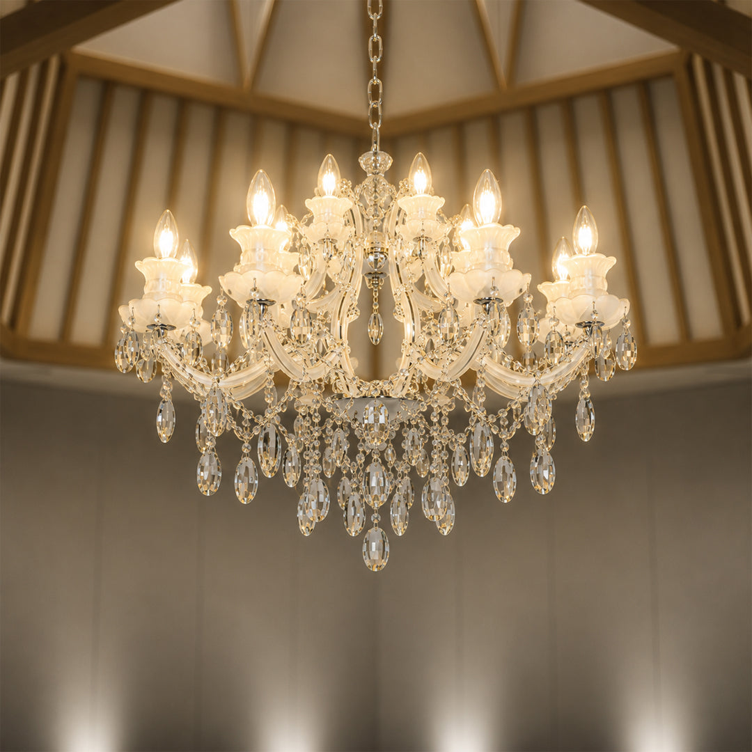 Lifestyle image of large gold metal candle style chandelier for luxury living room decor styling with elegant crystal detailing.
