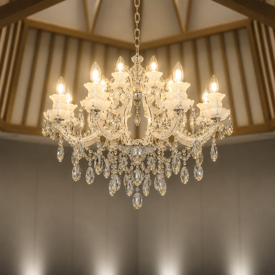 Lifestyle image of large gold metal candle style chandelier for luxury living room decor styling with elegant crystal detailing.