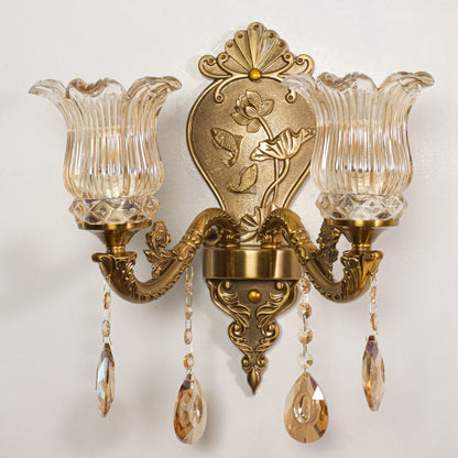 Detailed closeup of antique gold wall light with sculpted arms and crystal drops highlighting its premium lighting design.