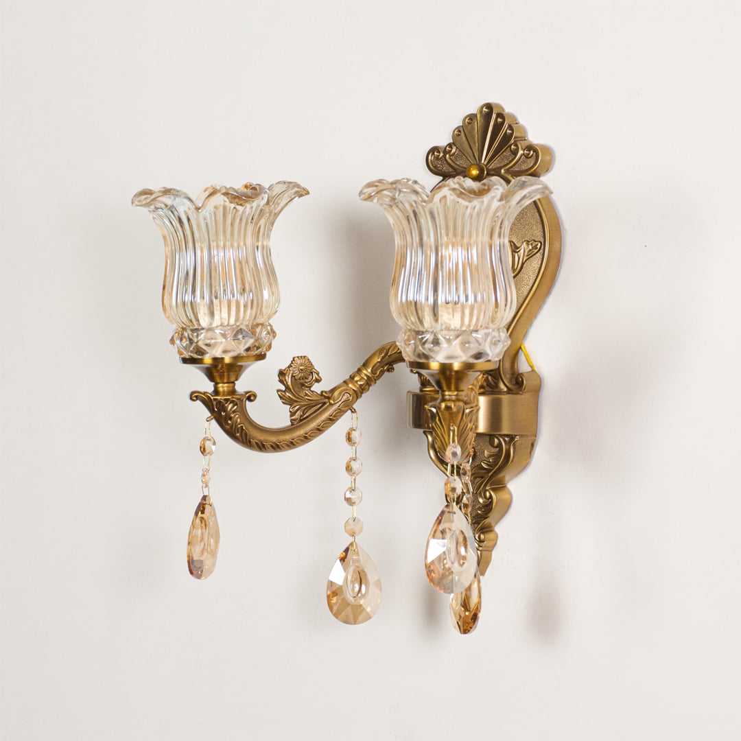 Wall light with antique gold frame and amber glass shades displayed on a white background for clear product detailing.