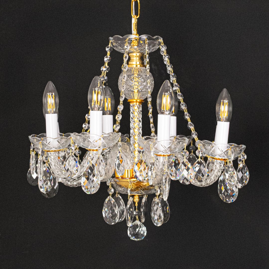 Gold metal crystal chandelier shown on black background highlighting premium crystal detailing for elegant interiors.