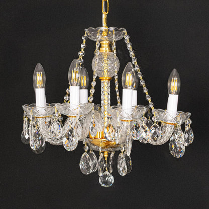 Gold metal crystal chandelier shown on black background highlighting premium crystal detailing for elegant interiors.